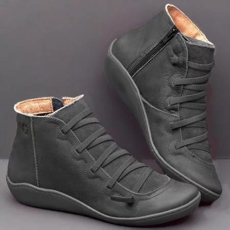 Dark gray suede snake print wedge ankle boots for women featuring laces threaded through eyelets and a zipper on the inner side.