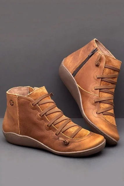 Tan leather snake print wedge ankle boots for women with laces and a side zipper.