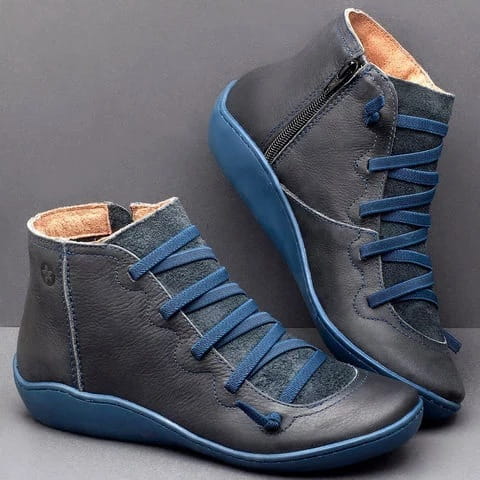 dark gray leather snake print wedge ankle boots for women with blue laces and matching blue soles shown from the back side