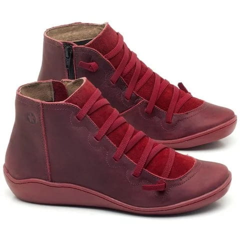 maroon suede high-top sneakers with matching laces and inner side zipper complement snake print wedge ankle boots for women.