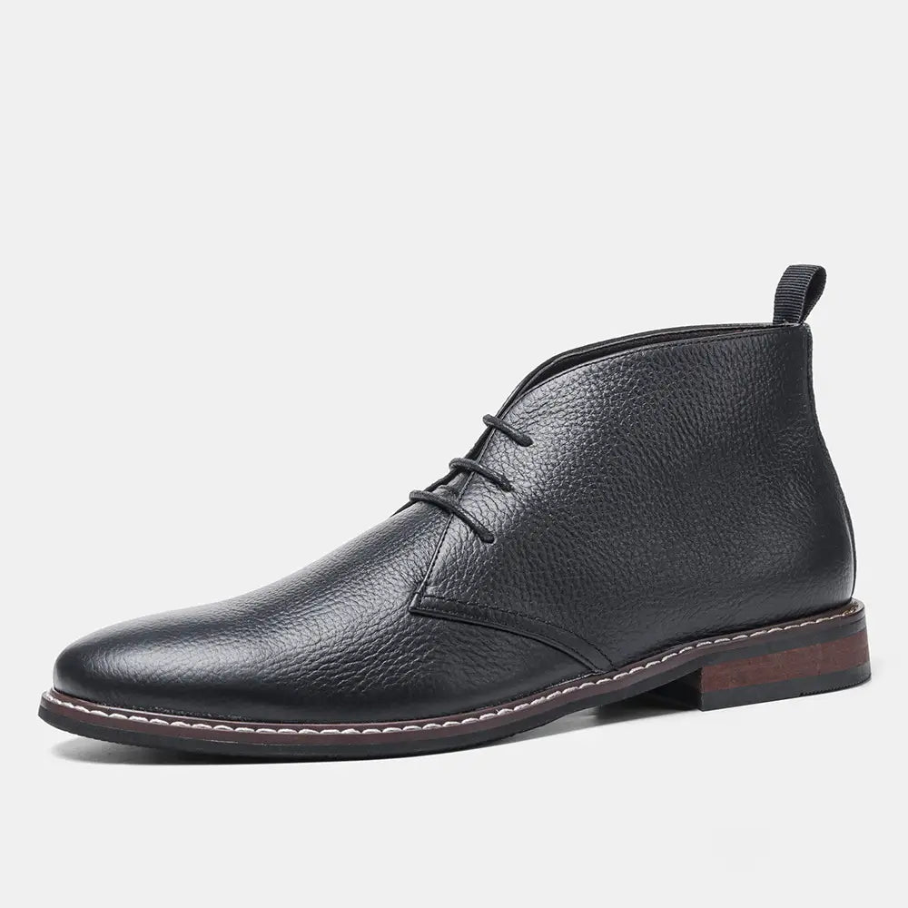 Men’s lychee pattern cowhide Chelsea Martin boot in black leather with textured surface and contrasting white stitching along the sole.