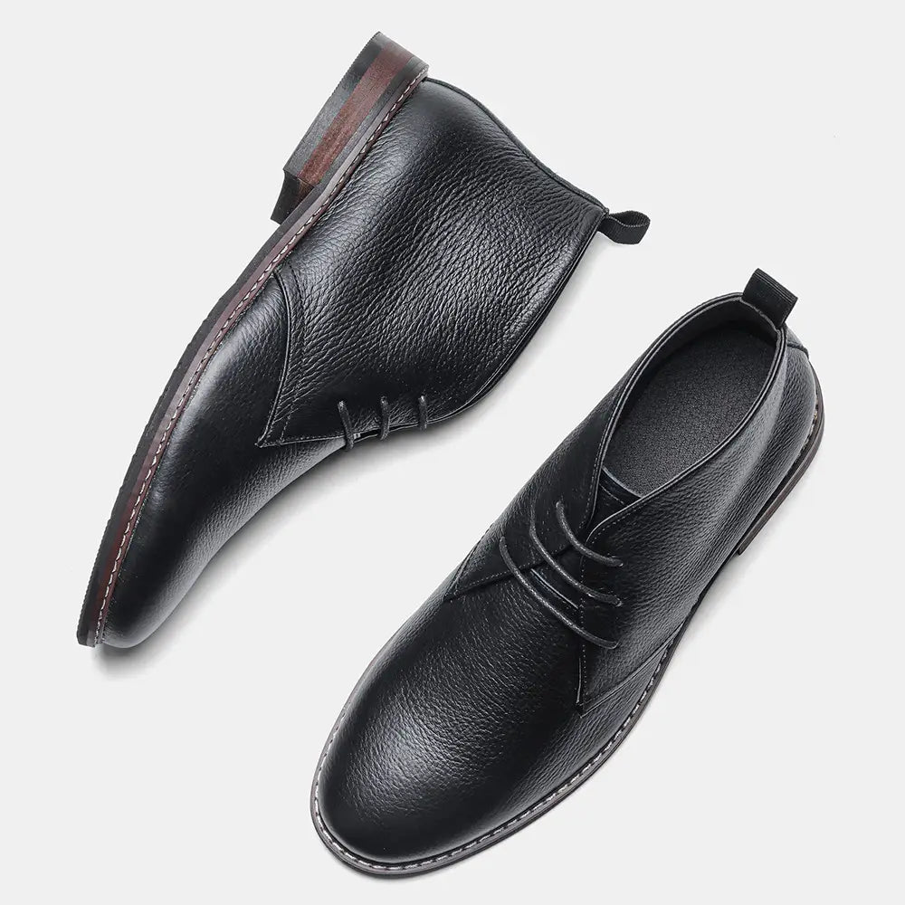 Men’s lychee pattern cowhide Chelsea Martin boots in black leather with a textured surface and contrasting stitching.