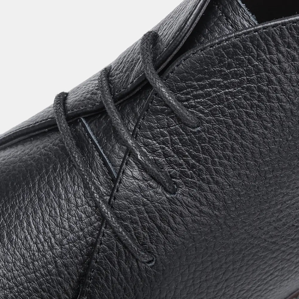 Men’s lychee pattern cowhide Chelsea Martin boots in black leather with pebbled texture and white sole stitching