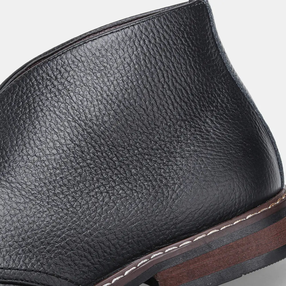 Men’s lychee pattern cowhide Chelsea Martin boots in black leather with pebbled texture and white sole stitching