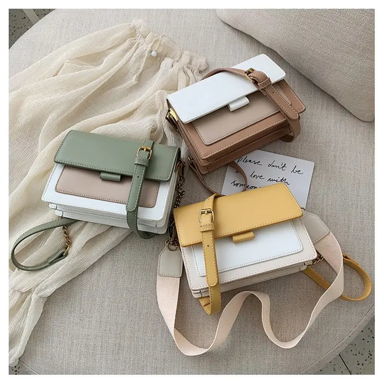 three pastel-colored square crossbody bags in soft green beige and yellow with two-tone faux leather layered panels and gold chains featuring a minimalist design