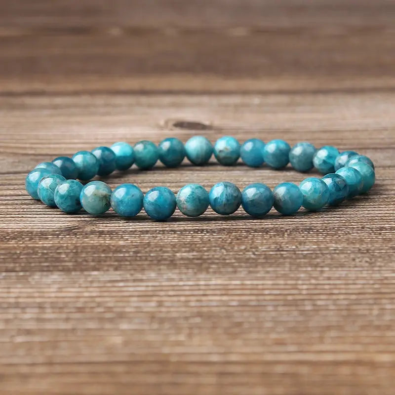 A natural blue apatite polished stone elastic bead bracelet featuring smooth round turquoise-blue gemstone beads.