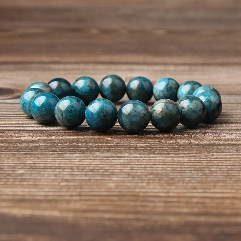 Natural blue apatite polished stone elastic bead bracelet featuring smooth round turquoise blue gemstones with subtle natural patterns.
