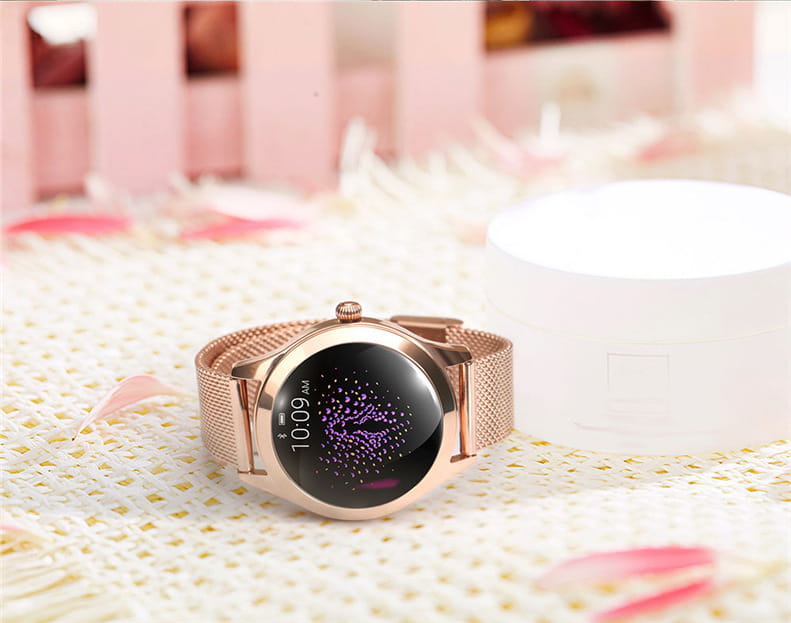 Rose gold butterfly smartwatch with a stainless steel mesh band and a circular black screen displaying a purple starry pattern and time 10 09 am.
