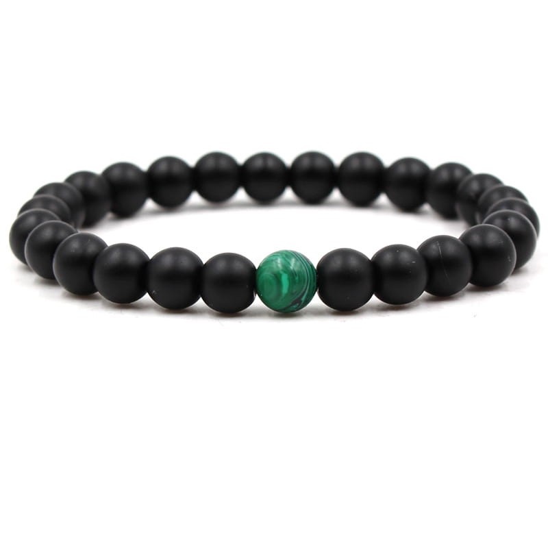 Matte black and green malachite elastic bead bracelet features black beads with a single green malachite accent bead.