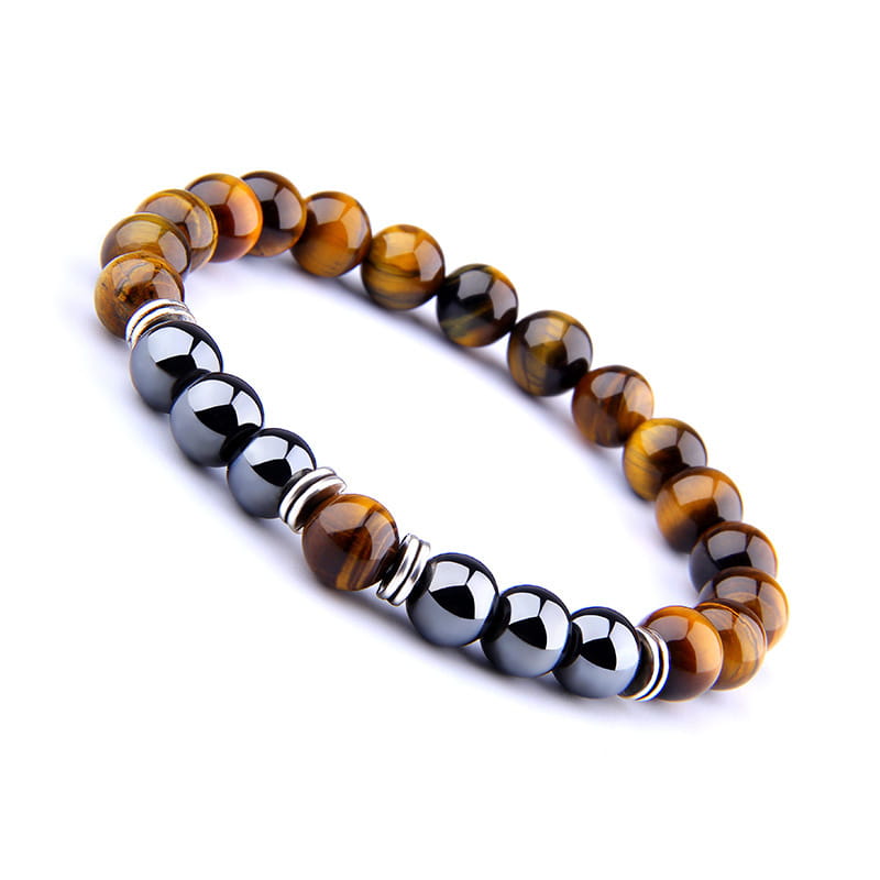 A beaded elastic bracelet featuring alternating tiger eye and black magnetic obsidian spheres accented with silver toned metal spacers.