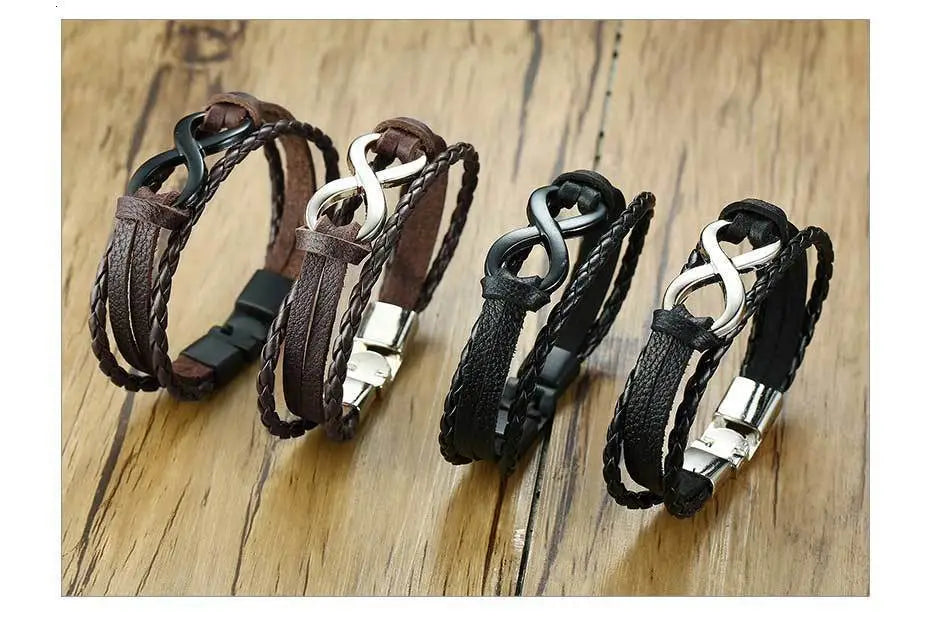Set of four unisex braided leather infinity and nautical charm bracelets in brown and black with silver toned metal clasps.