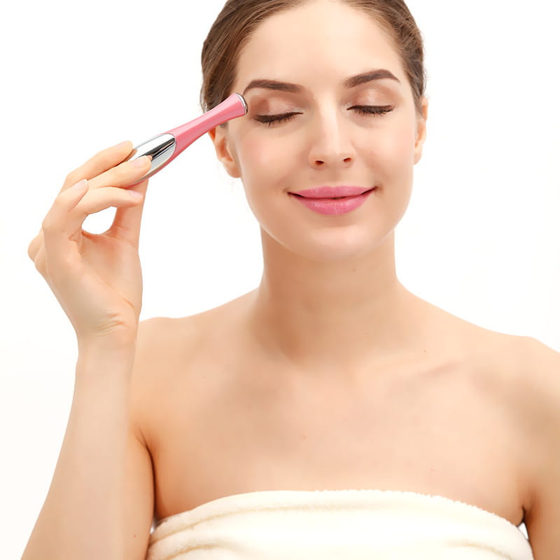 Pink and silver eye massager with sleek ergonomic design for wrinkle and dark circle removal.