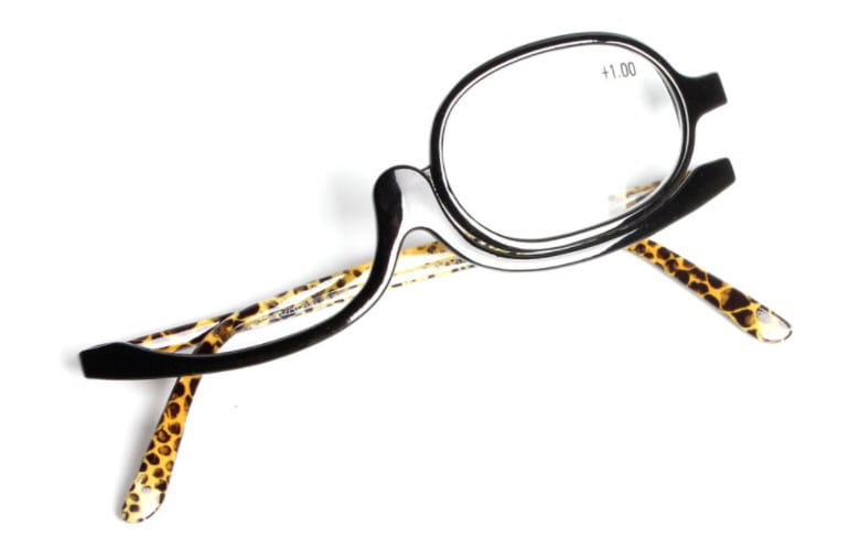 Black-framed makeup reading glasses with leopard-print temple arms and a plus 1.00 prescription mark on the lens in a plus 2.50 strength variety pack.