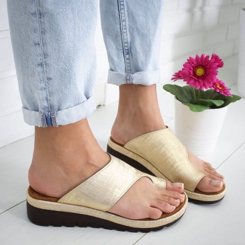 Gold-colored textured women’s platform slide sandals with a thick sole and an open-toe design suitable for beach and casual wear.