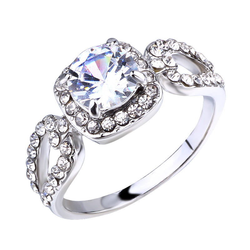 A sparkling silver square cut diamond halo engagement ring featuring a large clear gemstone surrounded by smaller crystals and an ornate band adorned with rhinestones.