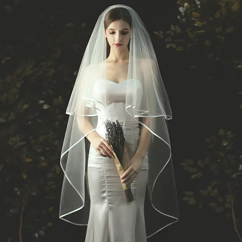 Double layer white tulle short veil with hair comb featuring a delicate sheer fabric with a subtle scalloped edge and soft draping.