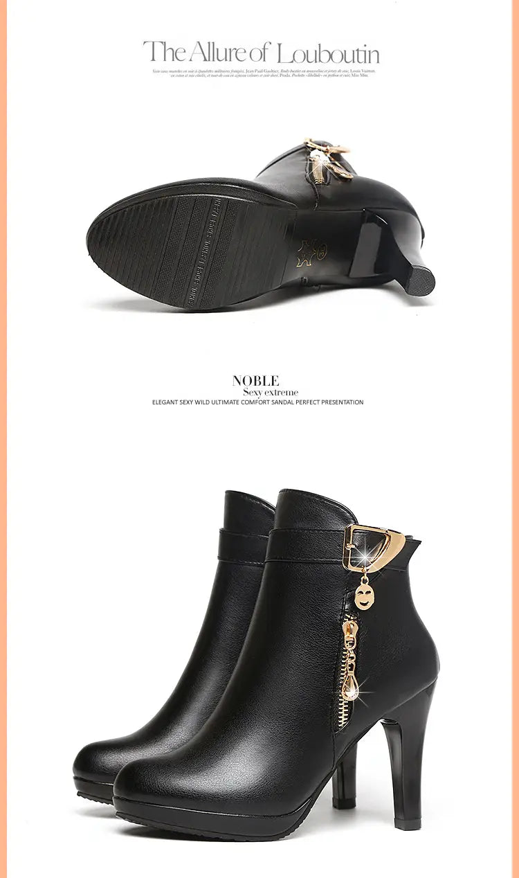 Black leather ankle boots with a gold-tone zipper pull featuring a smiling face charm and a high stiletto heel.
