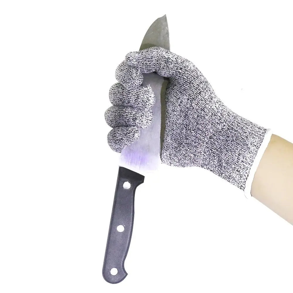 Gray textured cut resistant hppe safety glove gripping a black handled knife demonstrating precision and protection.