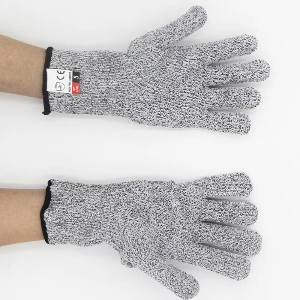 Gray and black speckled cut resistant work gloves with black cuff made of HPPE material worn on hands for safety and protection.