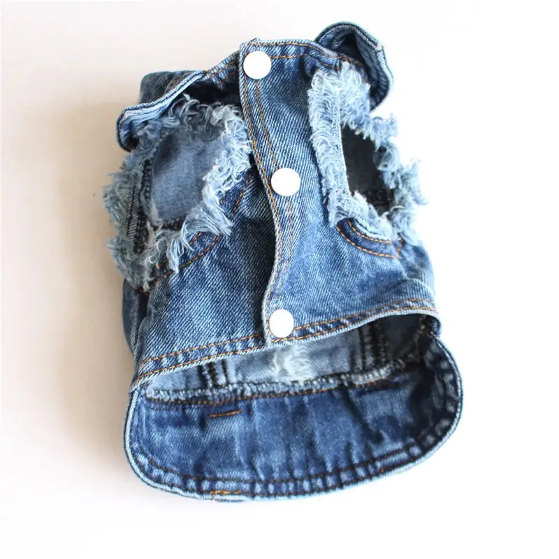 Blue denim dog vest with frayed edges and white buttons from the denim dog jacket strawberry embroidery puppy vest collection.