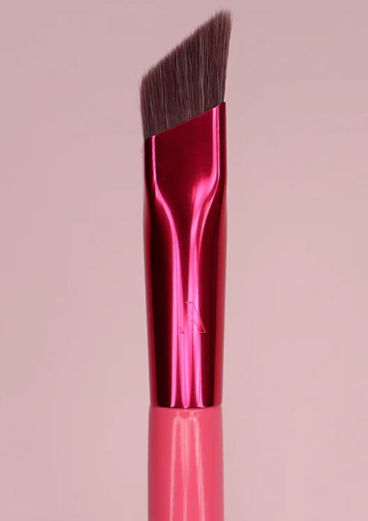 A vibrant pink angled eyebrow brush with a glossy metallic handle and dark brown bristles for precise gel application.
