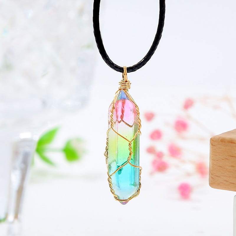 A rainbow-colored geometric crystal wire wrapped pendant necklace hanging from a black cord.