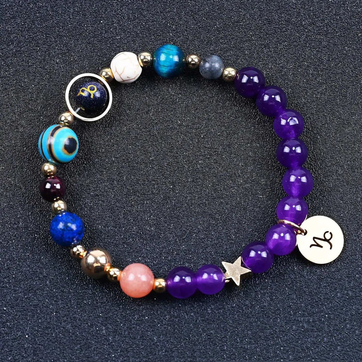 Natural amethyst and agate twelve zodiac beaded bracelet featuring vibrant purple agate beads, a turquoise tiger eye bead, and blue, pink, white, and gold-toned accent stones.