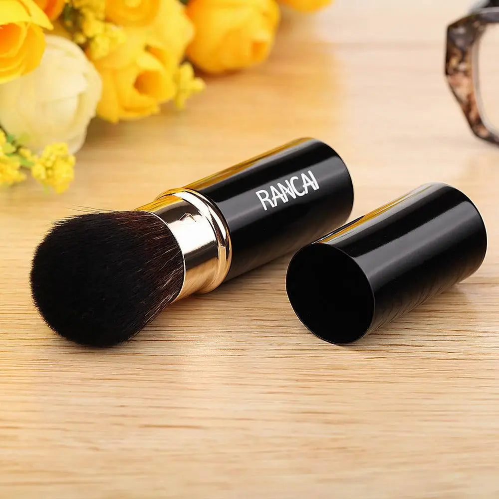 Retractable makeup brush mini rancai in black with gold accents and a matching cylindrical case for convenient makeup application and storage.