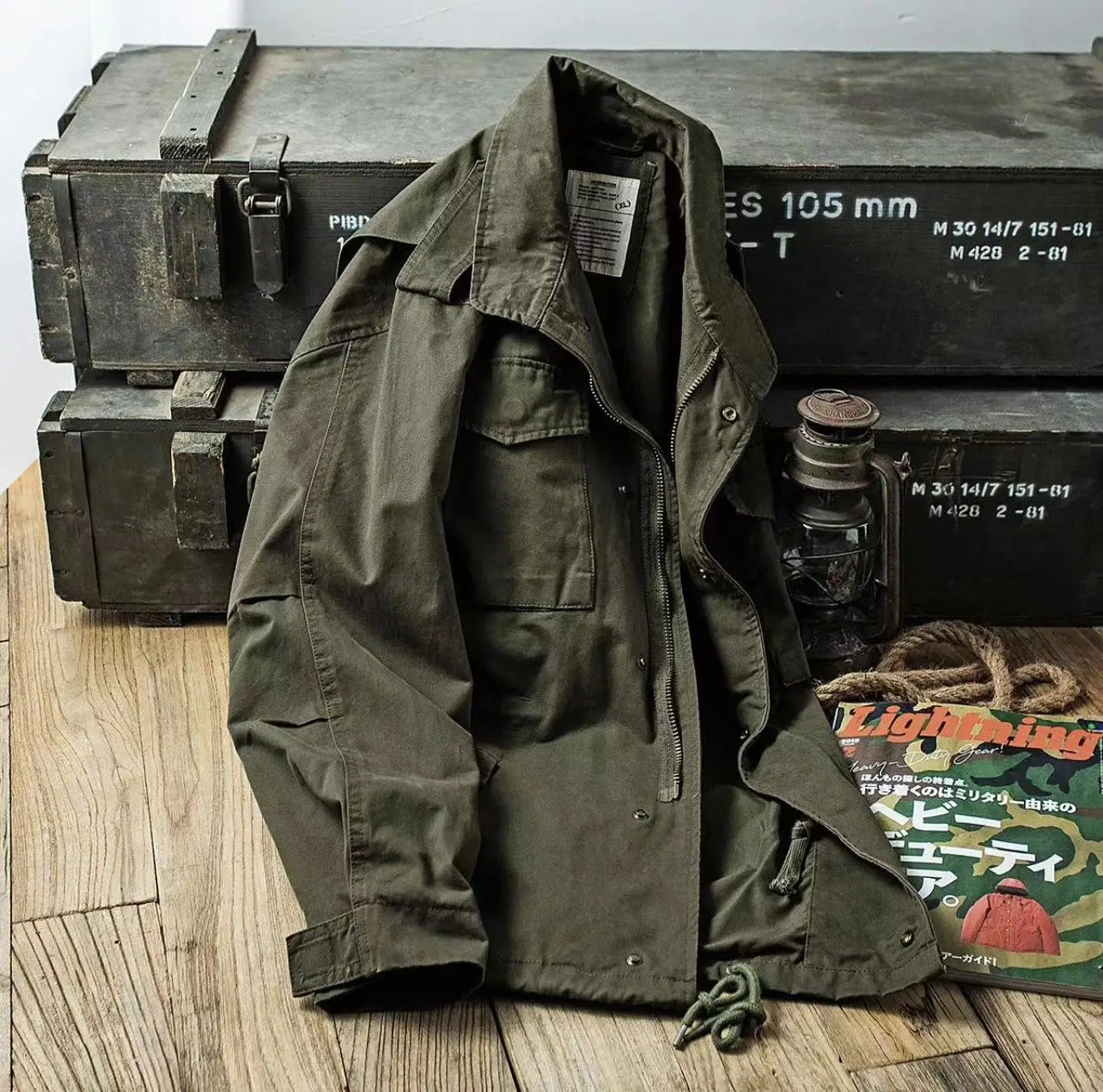 Men’s vintage olive green cotton field jacket featuring flap pockets and buttoned cuffs.