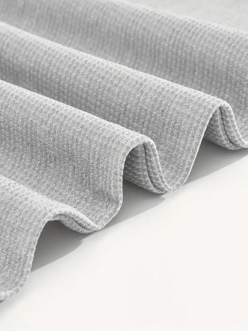 gray waffle-knit fabric with a textured ribbed pattern featured in a mens minimalist solid color sweatshirt jogger set.