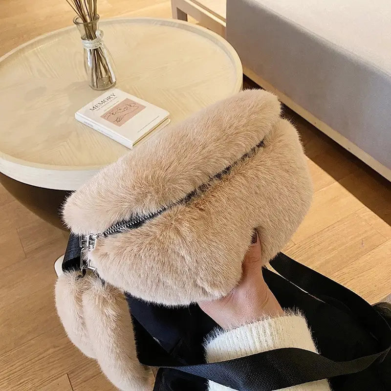 Beige plush faux fur fanny pack crossbody messenger bag featuring a black zipper and adjustable strap.