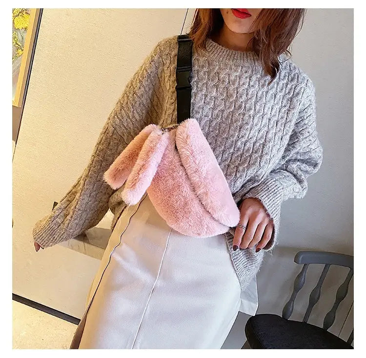 Pink fuzzy bunny-shaped plush faux fur fanny pack crossbody messenger bag with soft plush material and black adjustable strap.
