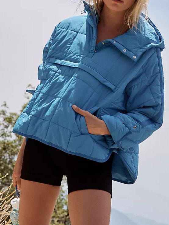 Blue cotton hooded quilted puffer jacket for women featuring front pockets and a warm insulated design.