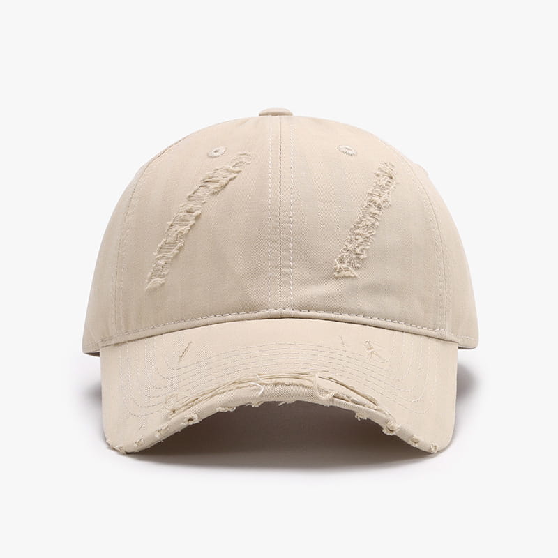 Beige distressed baseball cap for men made of ripped cotton with frayed edges and subtle stitching details.