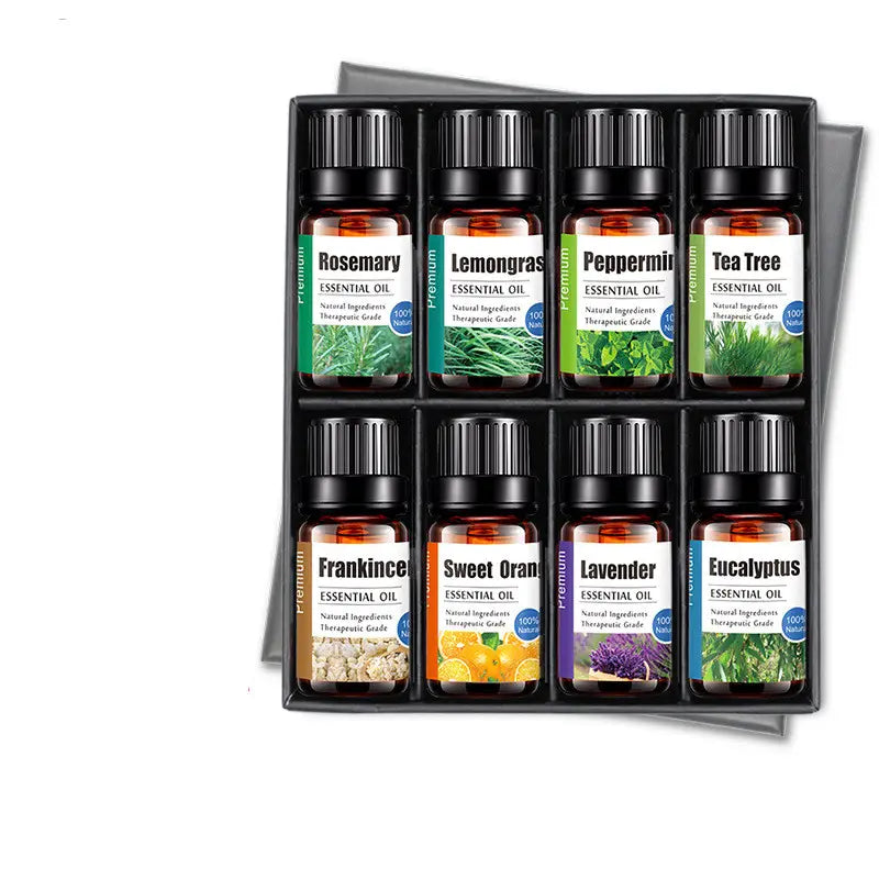 Set of eight amber glass bottles with black caps containing sage essential oil 10ml pure aroma diffuser liquid in a sleek black gift box.