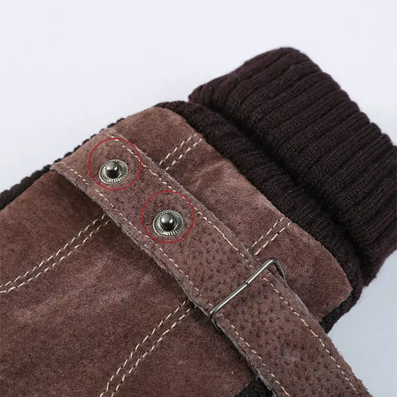 Men’s touch screen winter leather gloves featuring a brown suede strap with silver-toned metal snap buttons and contrasting white stitching.