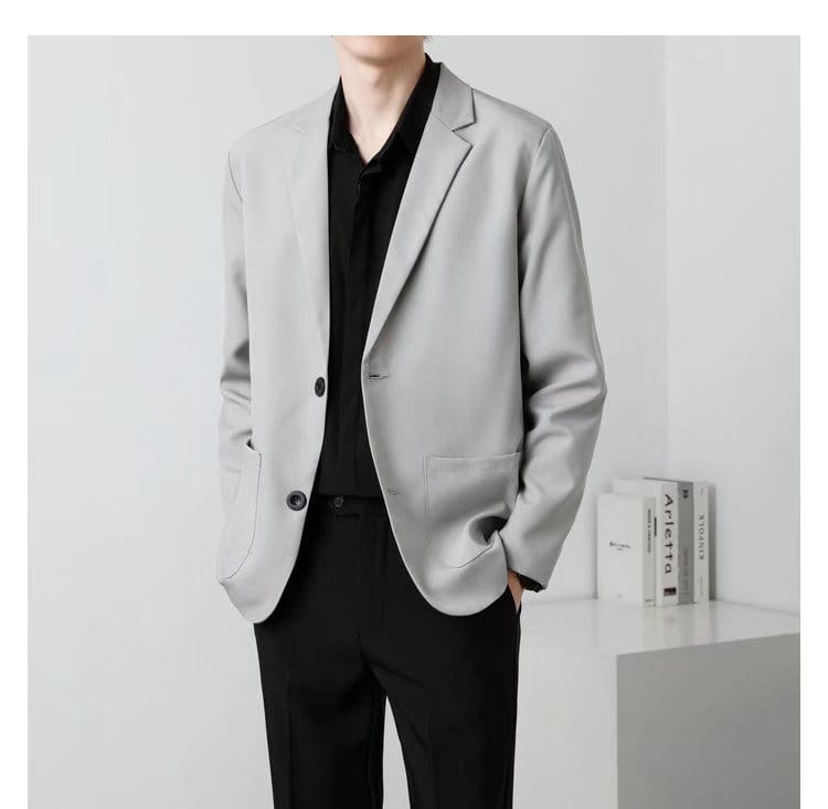 A men slim fit two button blazer in light gray with a modern cut and subtle texture.
