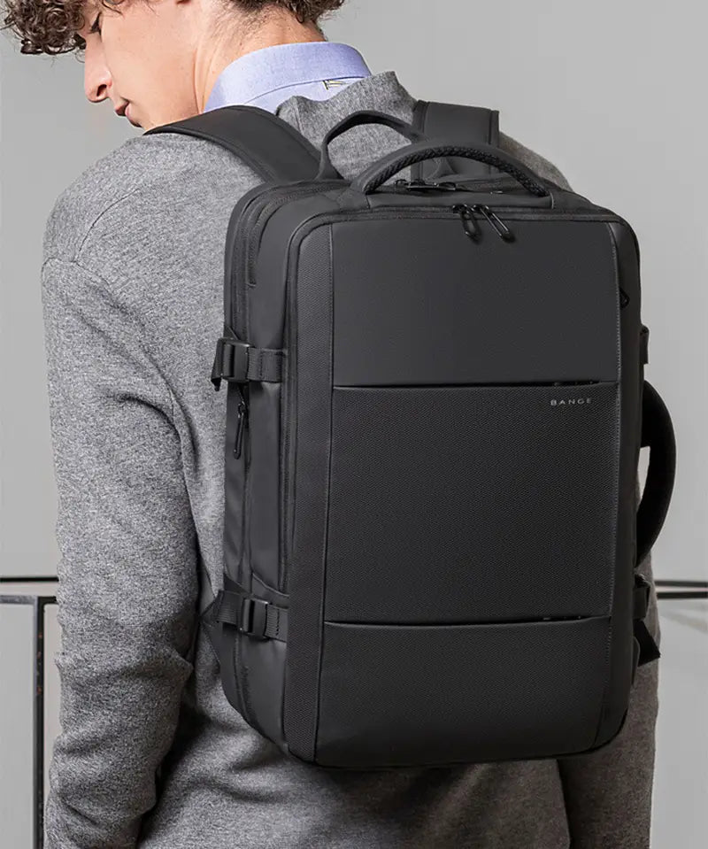 Black bange business backpack with waterproof textured fabric and sleek minimalist design for large capacity laptop storage.