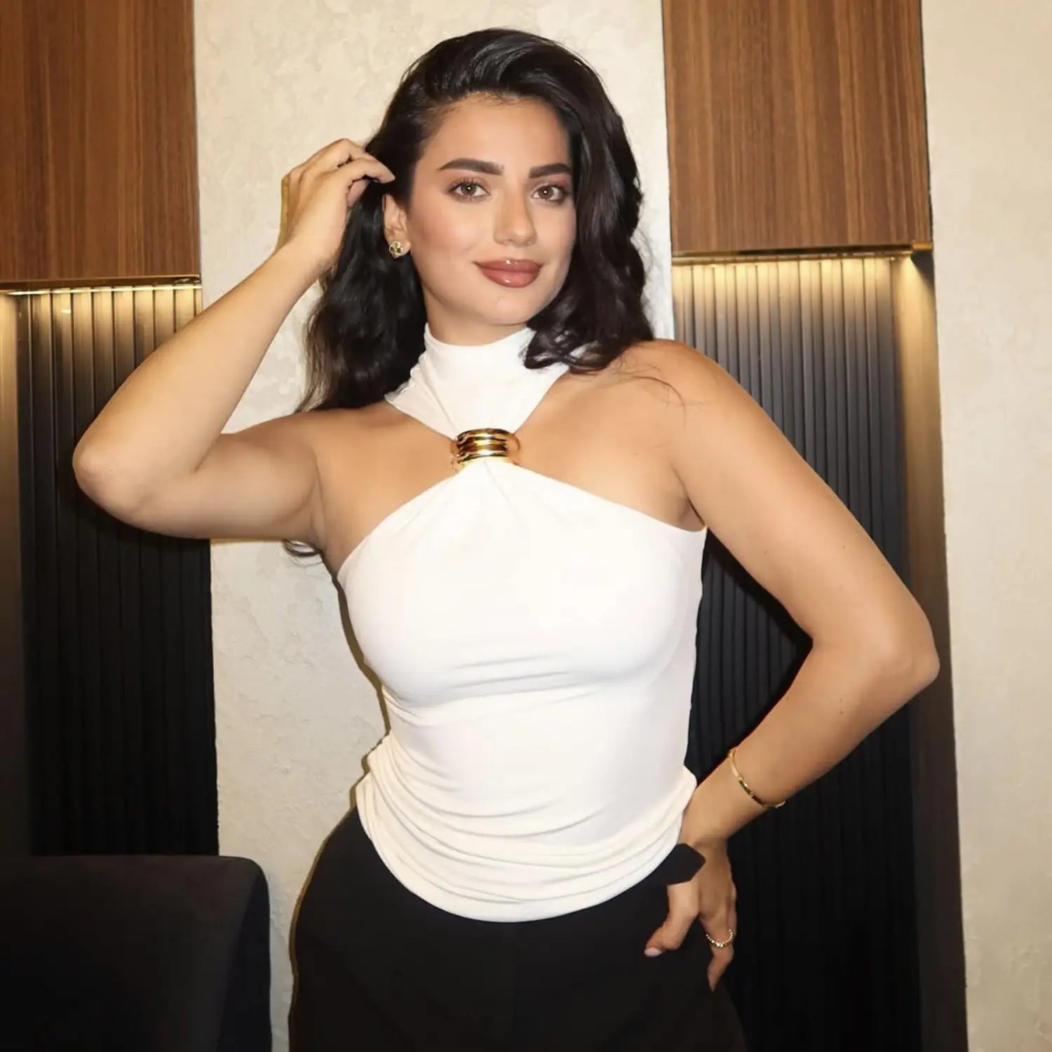 white one-shoulder halter stretch top with a gold-toned circular clasp at the neckline designed for stylish occasions