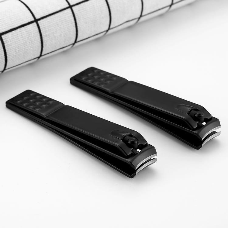 Black stainless steel nail clippers with textured grip handles and metallic cutting edges designed for precise nail trimming.