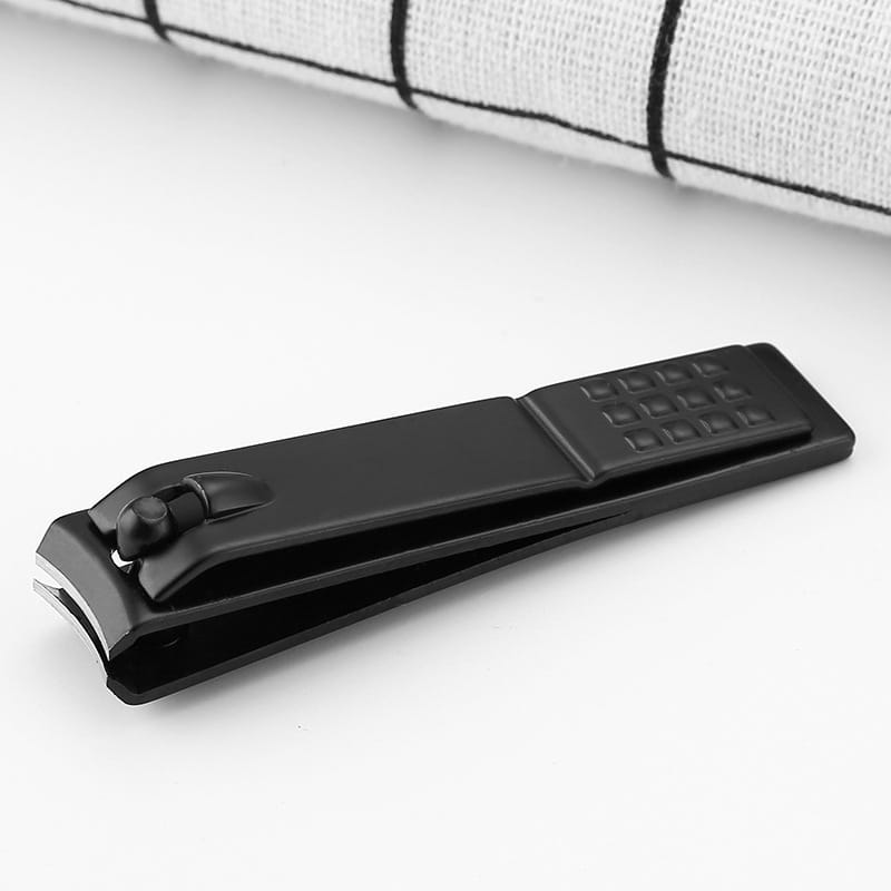 Black stainless steel nail clippers with a textured grip and metallic cutting edge designed for precise grooming.