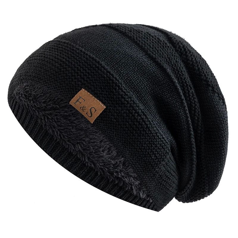 Black knitted fleece lined beanie cap with a fuzzy interior and a brown leather patch featuring the f&s logo.