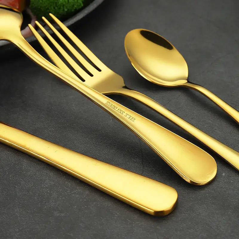 gold stainless steel cutlery set featuring fork spoon and knife with sleek modern handles in gold finish for 24 piece tableware collection