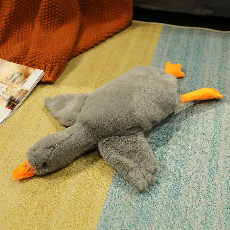 A plush gray duck toy with orange beak and feet made of soft fabric featured as a giant white goose plush sleeping pillow toy.