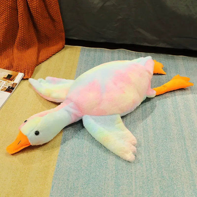 Giant white goose plush sleeping pillow toy featuring a soft pastel pink and white tie-dye body with orange beak and feet and black bead eyes.