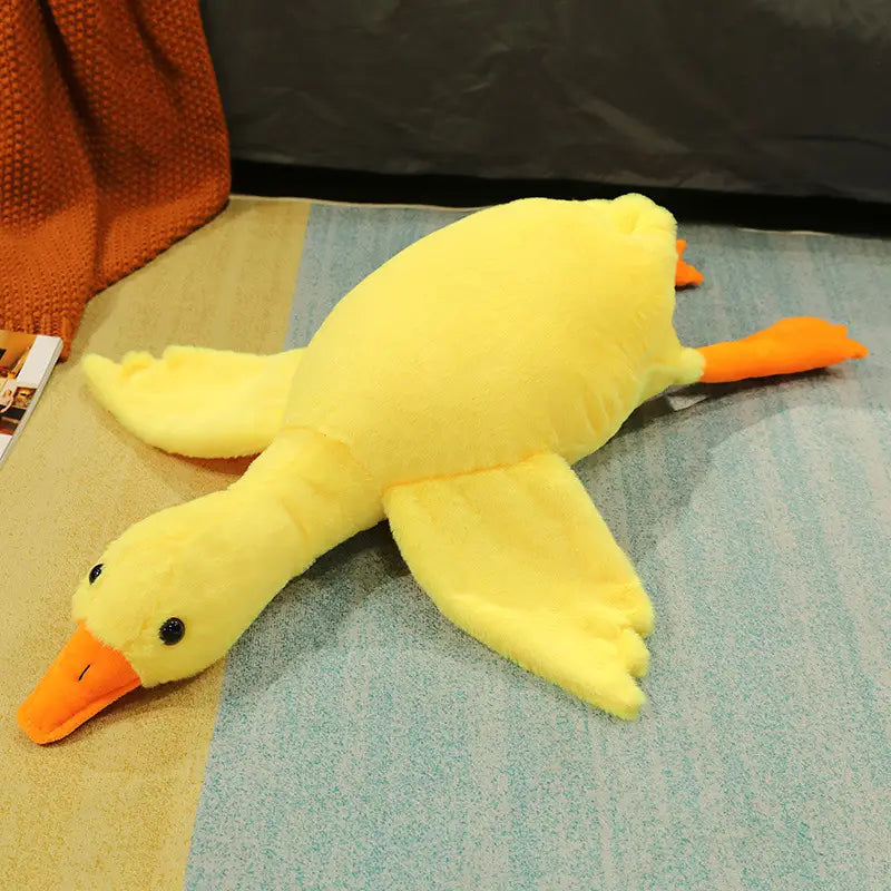 a plush yellow duck with orange beak and feet made of soft fabric suitable as a giant white goose plush sleeping pillow toy
