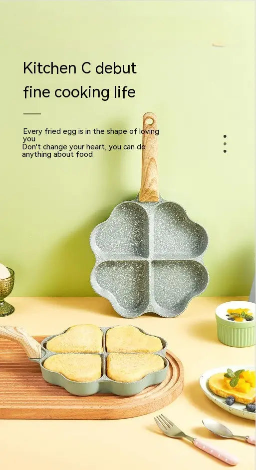 Gray speckled nonstick four-leaf clover-shaped frying pan with wooden handle designed for frying eggs.