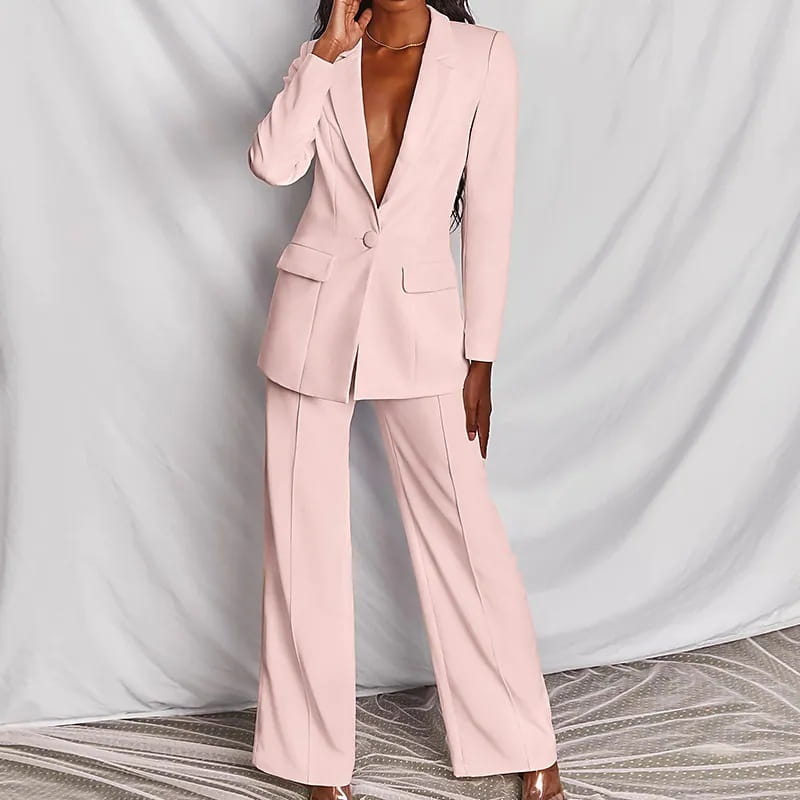 A sleek blush pink women’s tailored blazer and wide leg trouser suit set made from smooth fabric perfect for professional wear.