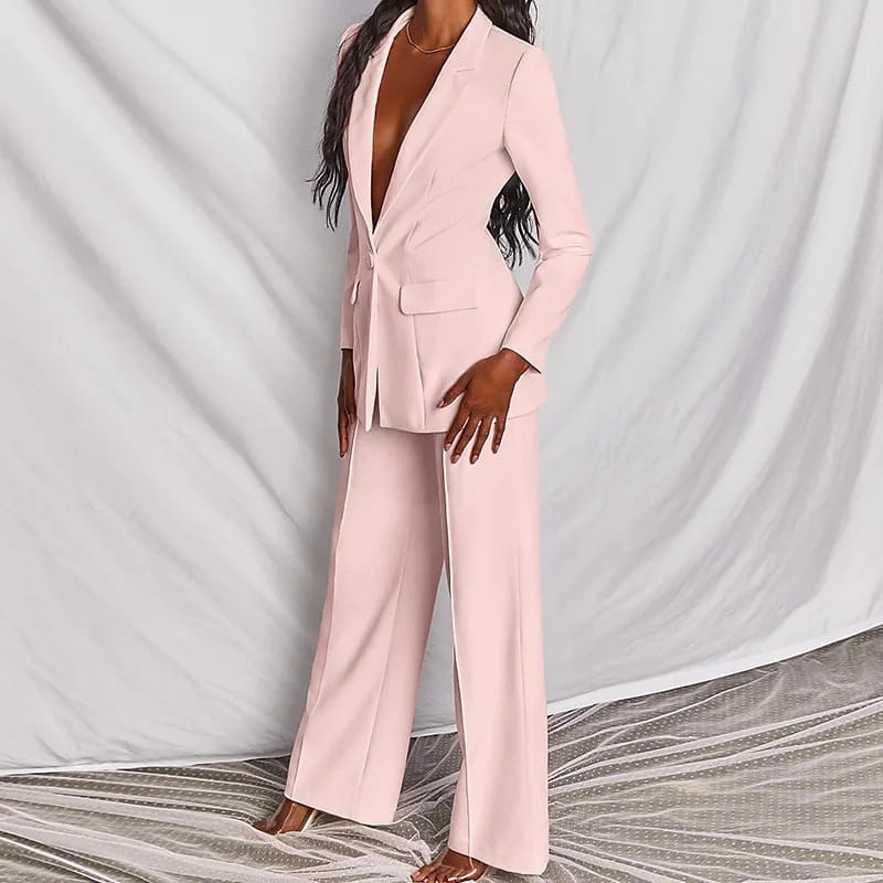 A sleek blush pink women’s tailored blazer and wide leg trouser suit set made from smooth fabric for a polished professional look.