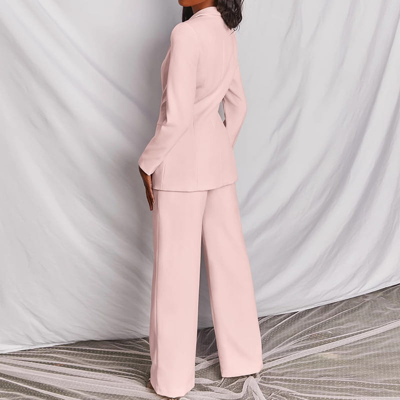A soft blush pink women’s tailored blazer and wide leg trouser suit set crafted from smooth lightweight fabric.